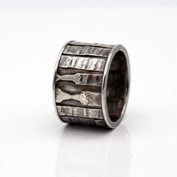 fused textural patterns sterling silver band style ring with patina Edit alt text