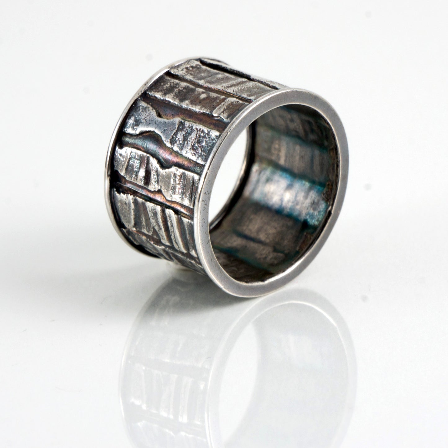 fused textural patterns sterling silver band style ring with patina Edit alt text