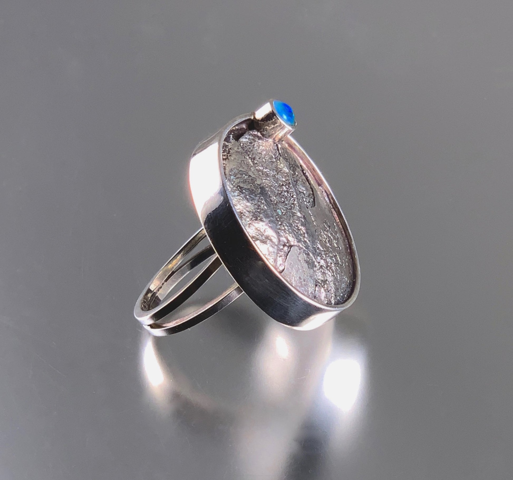 statement ring of sterling silver with texture, patina and opal