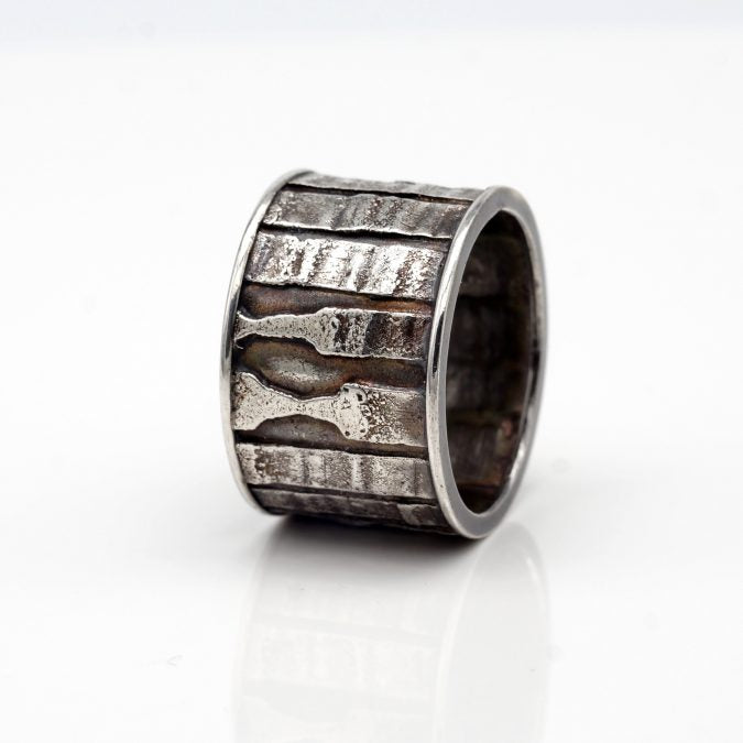 fused textural patterns sterling silver band style ring with patina  Edit alt text